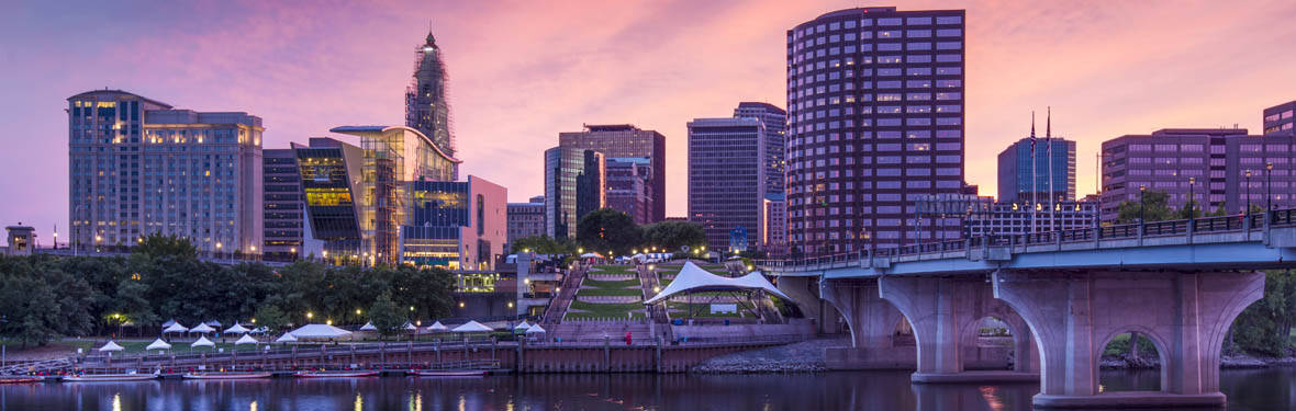 The skyline of downtown Hartford, Connecticut at dusk from across the Connecticut River.